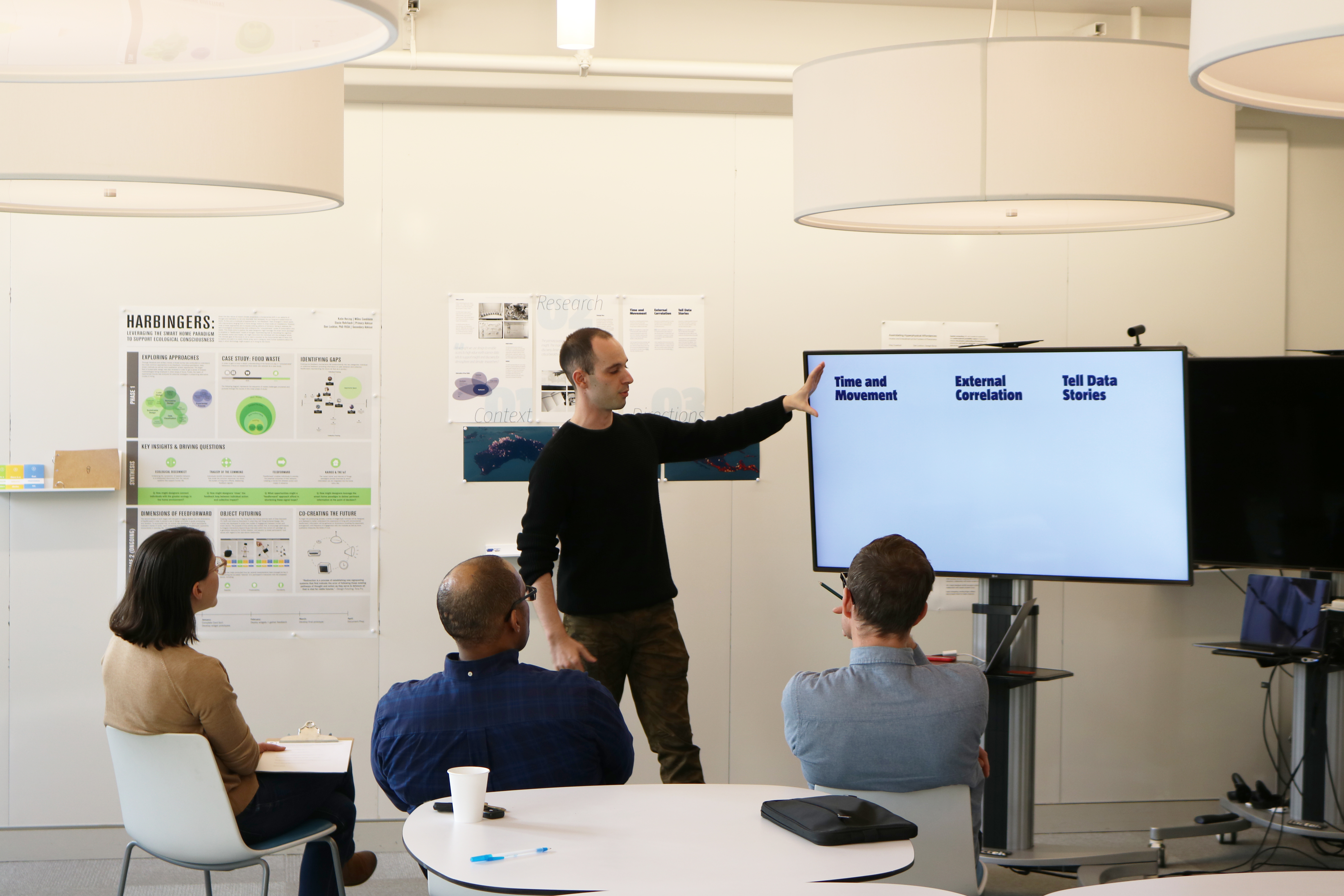 A grad student giving a presentation in the Grad Studio