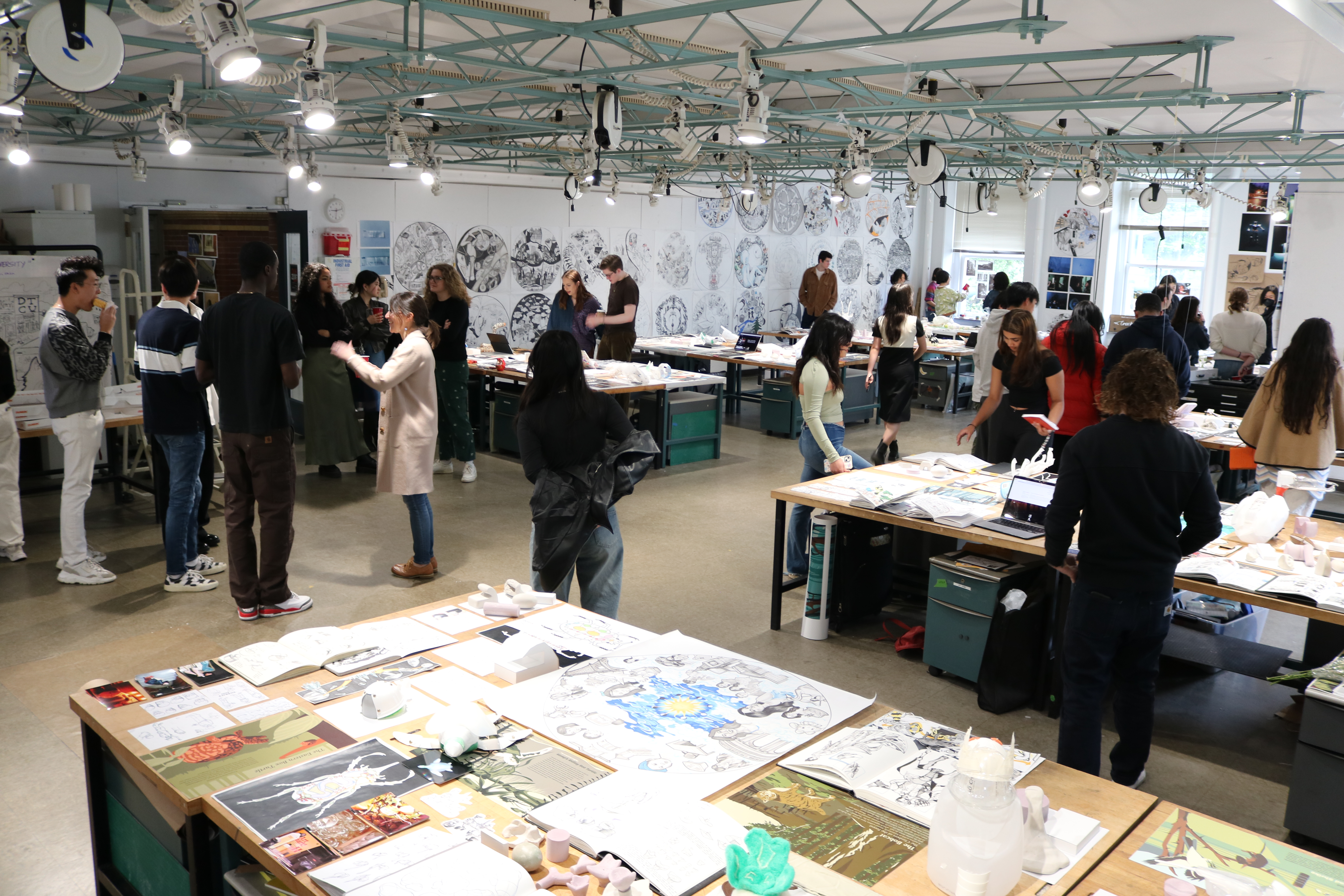 A crowd viewing work hung in our First Year studio.