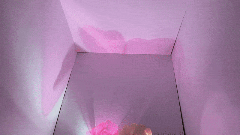 Colorful lights traveling across the inside of a box