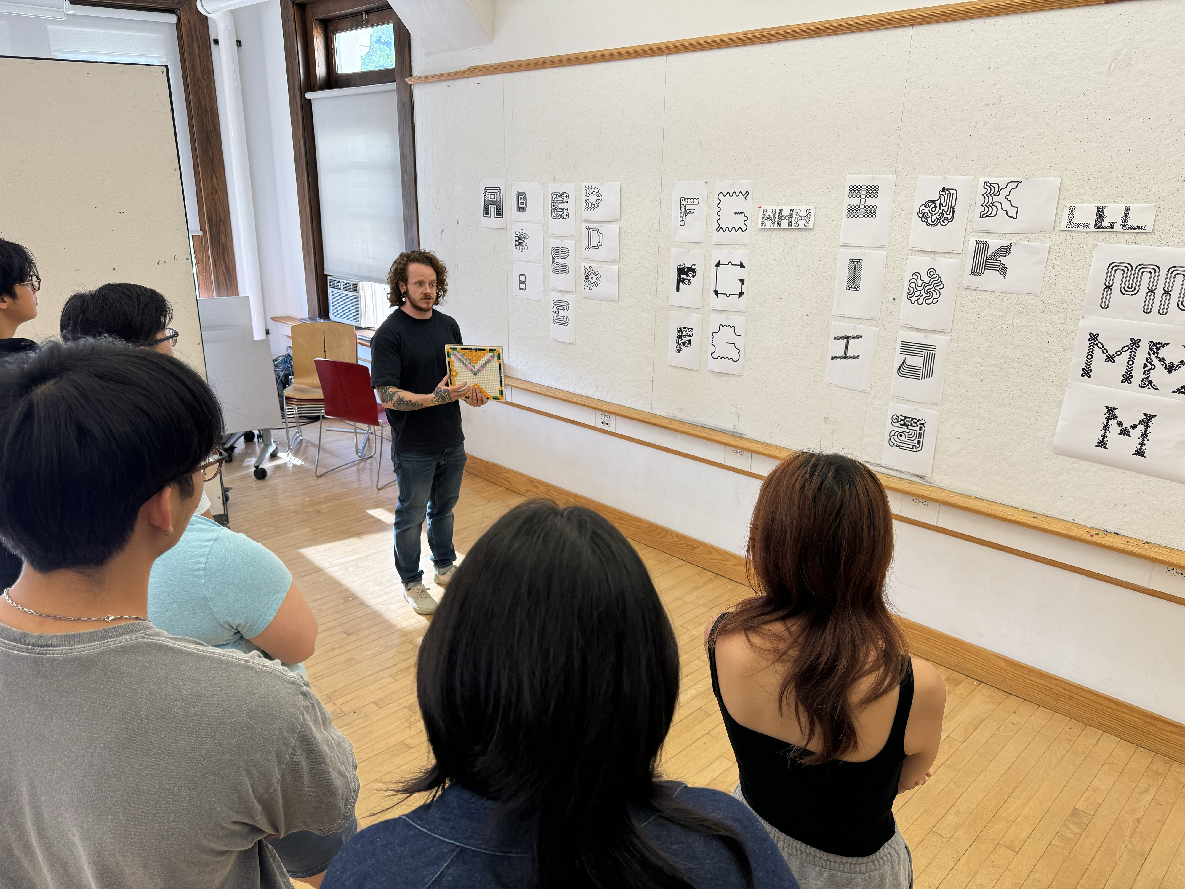 Kelsey Elder showing experimental typography to a class