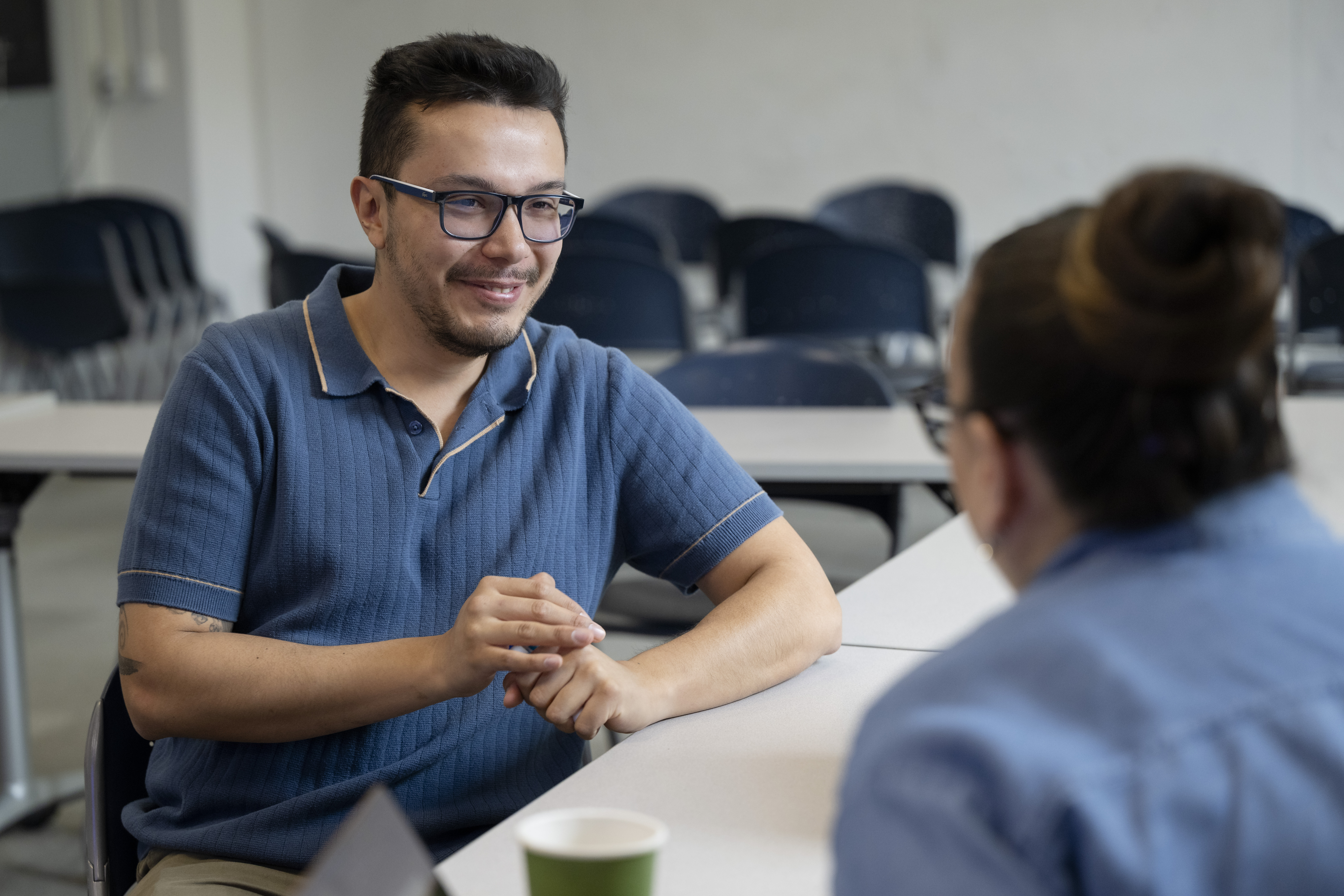 Luis Garcia speaking with a student