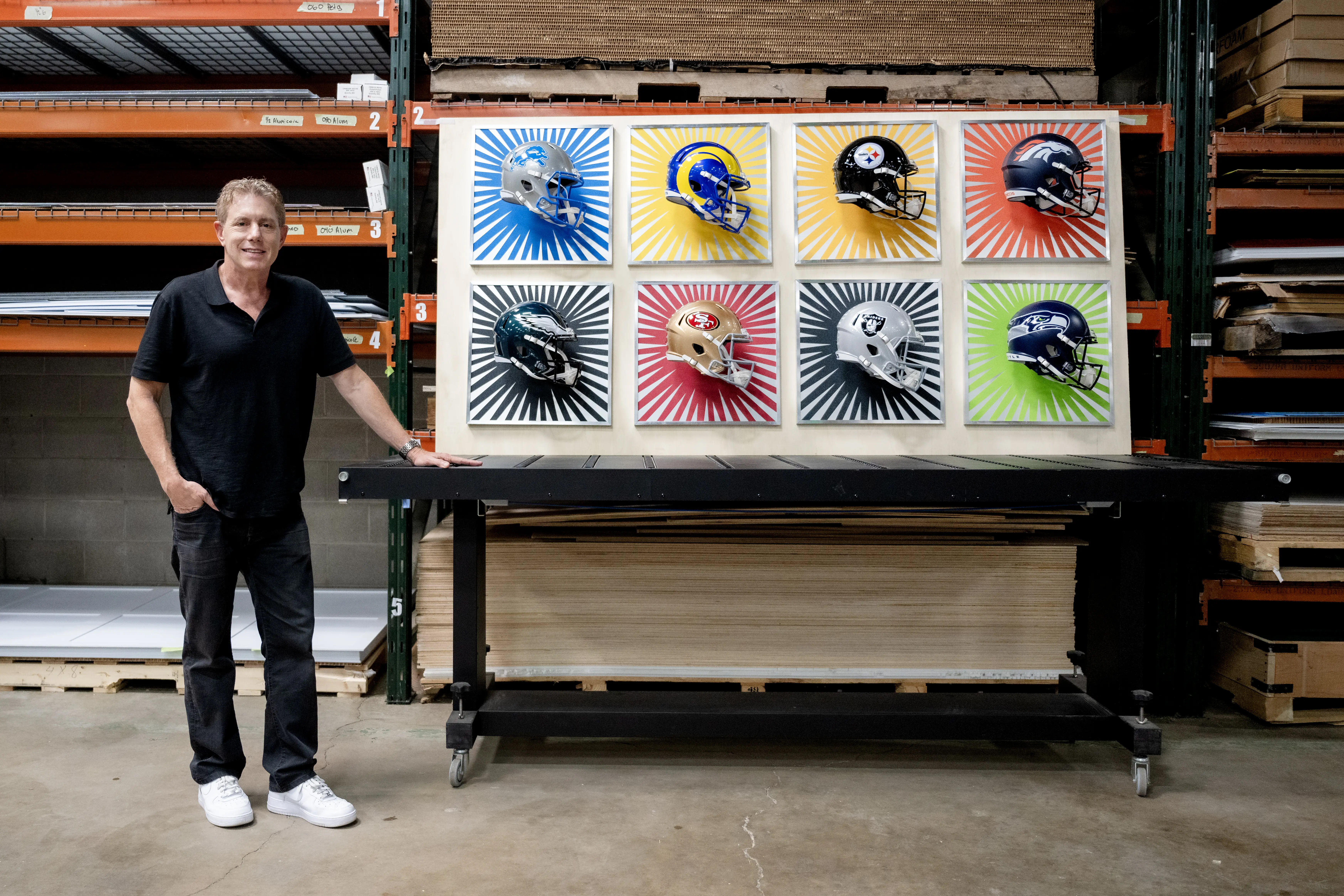 Burton Morris standing next to his NFL art