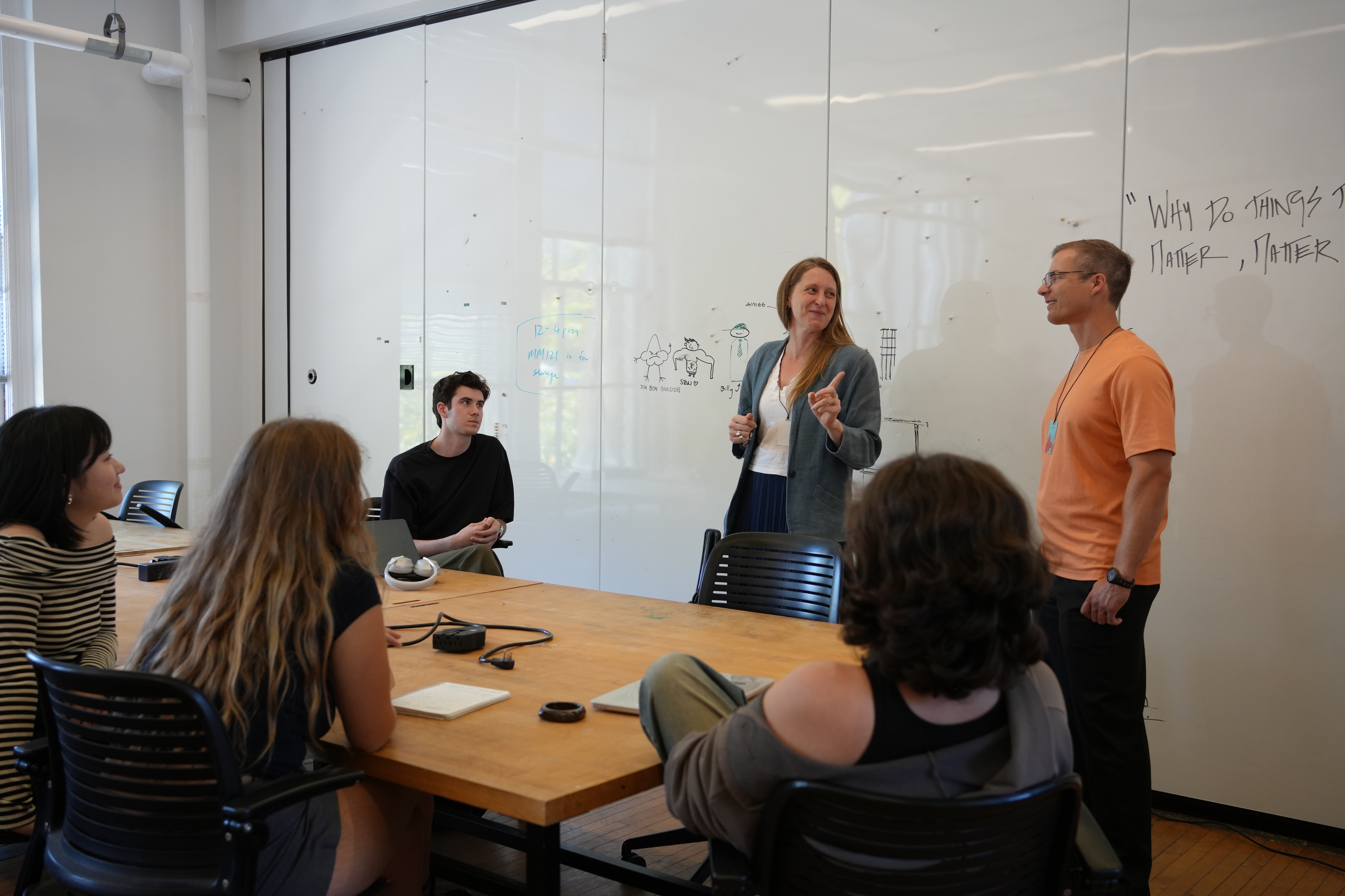 Design professionals speaking with students