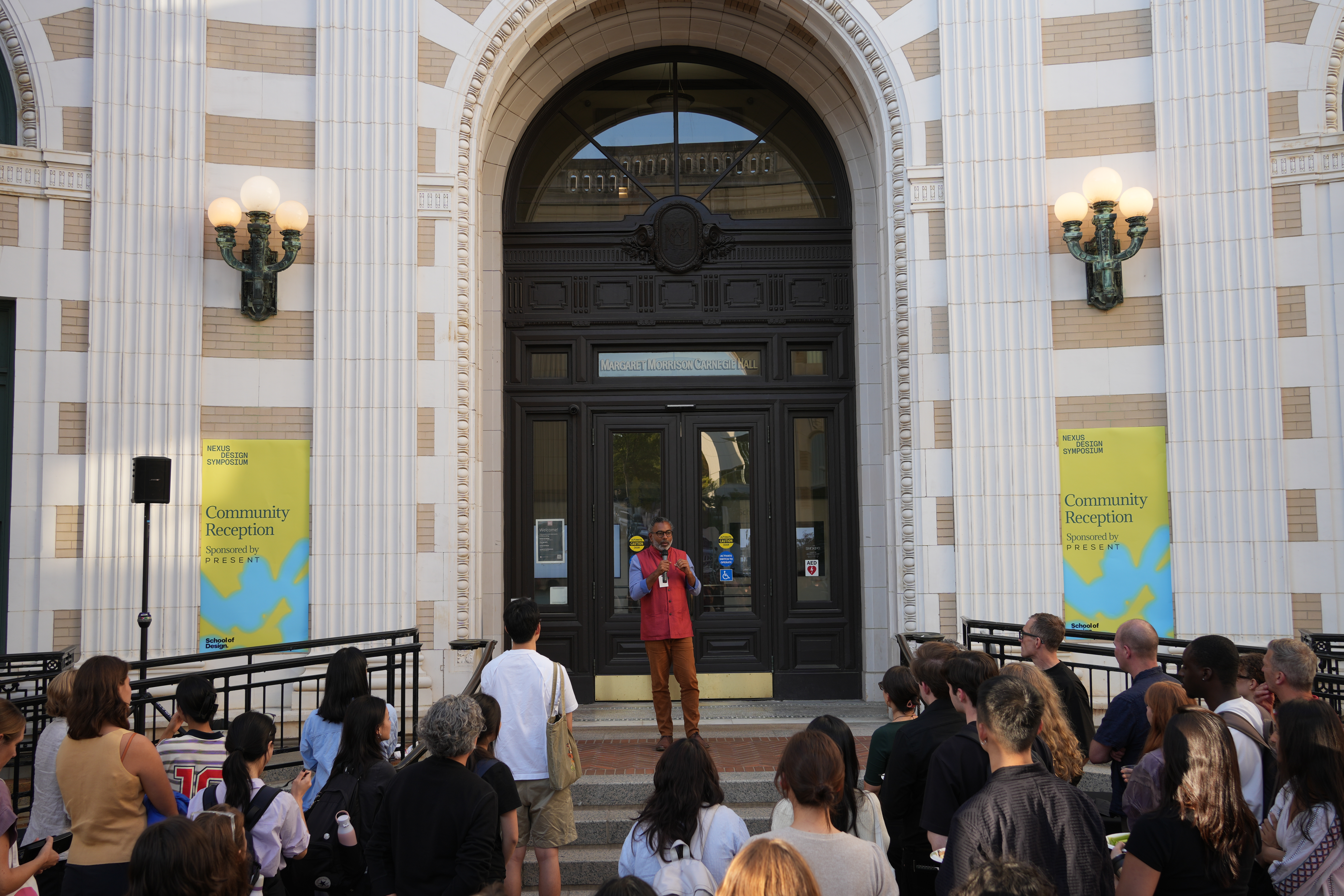 A man addressing a crowd in front of MMCH