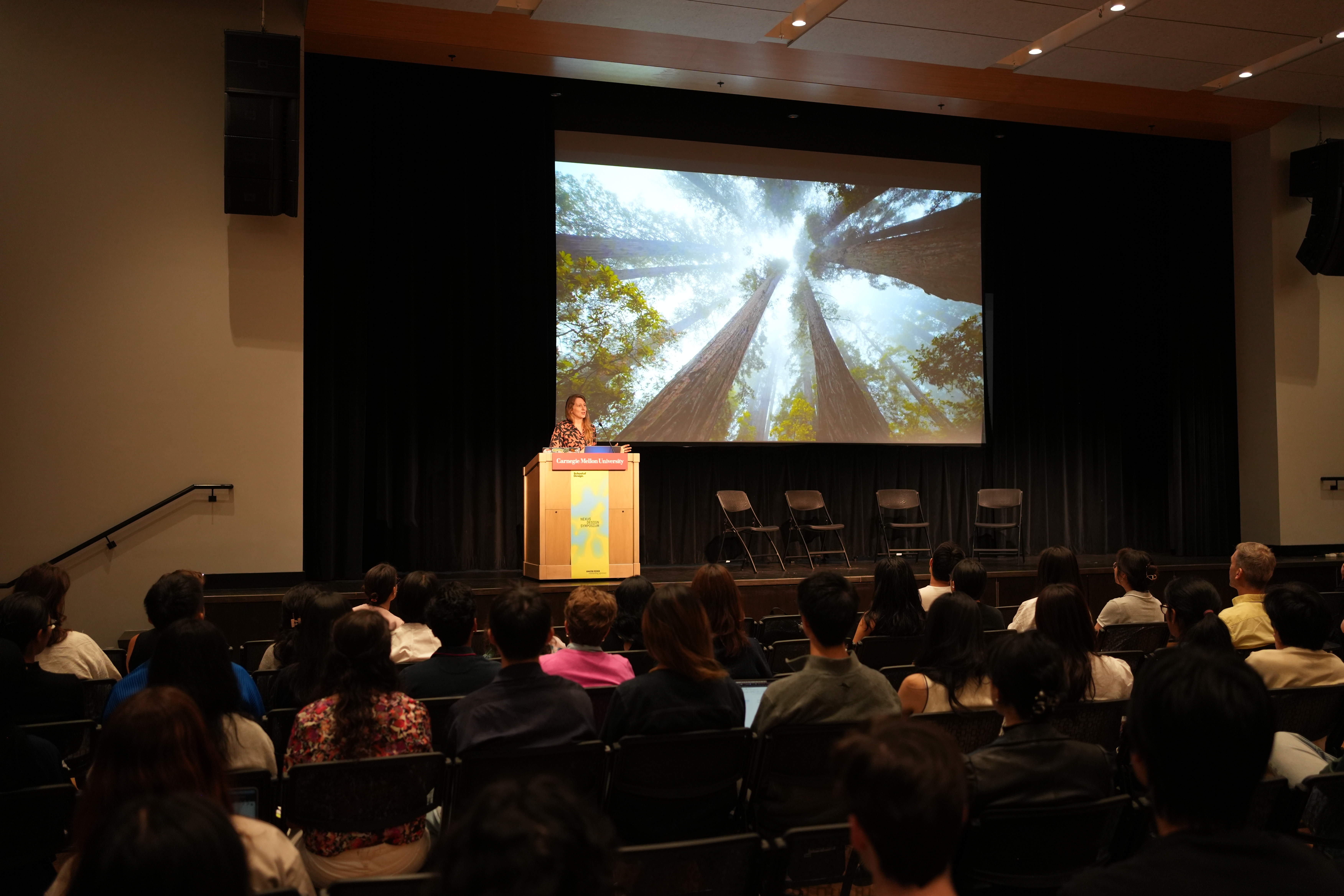Megan Neese speaking at the Nexus Design Symposium