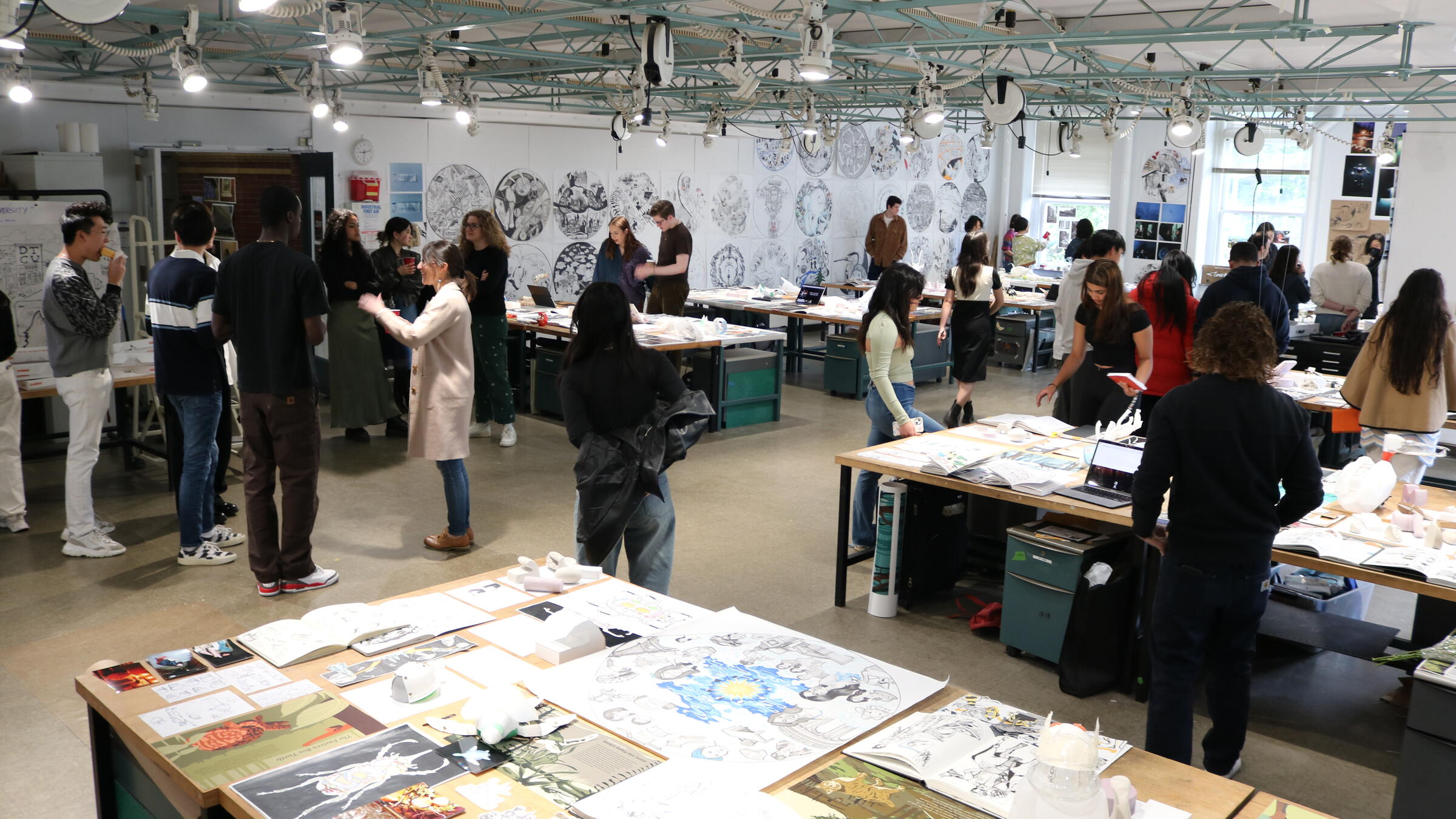 A crowd viewing work hung in our First Year studio.