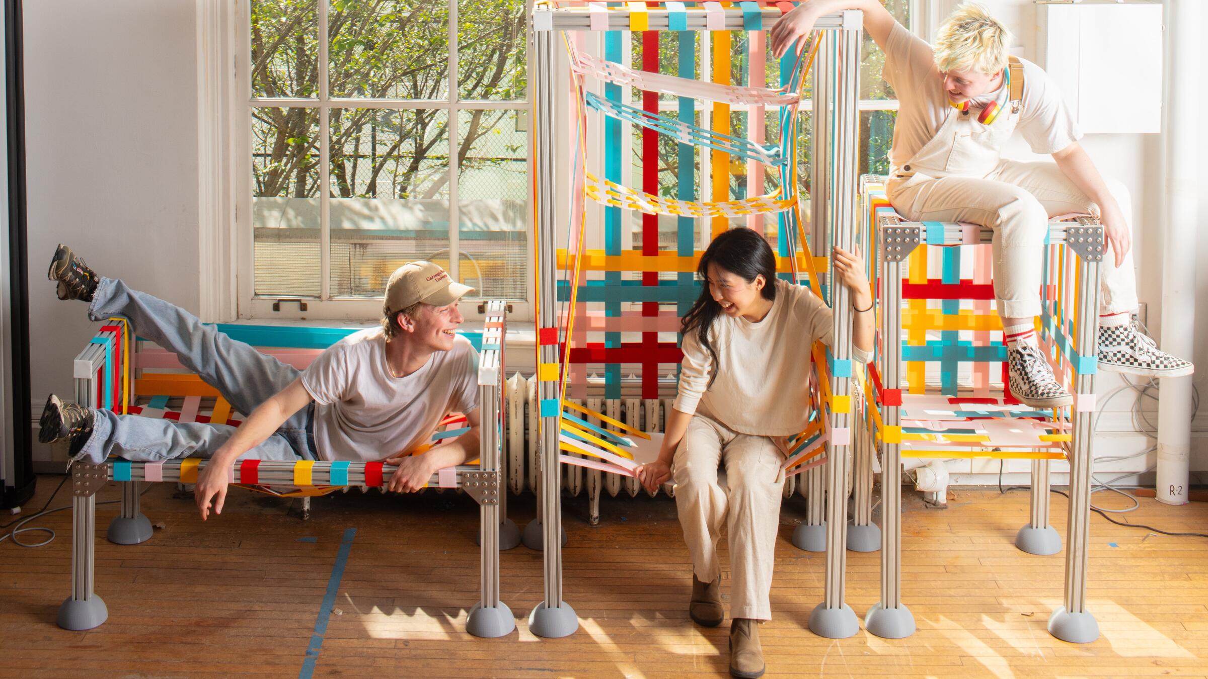 3 people sitting on 3 pieces of colorful furniture