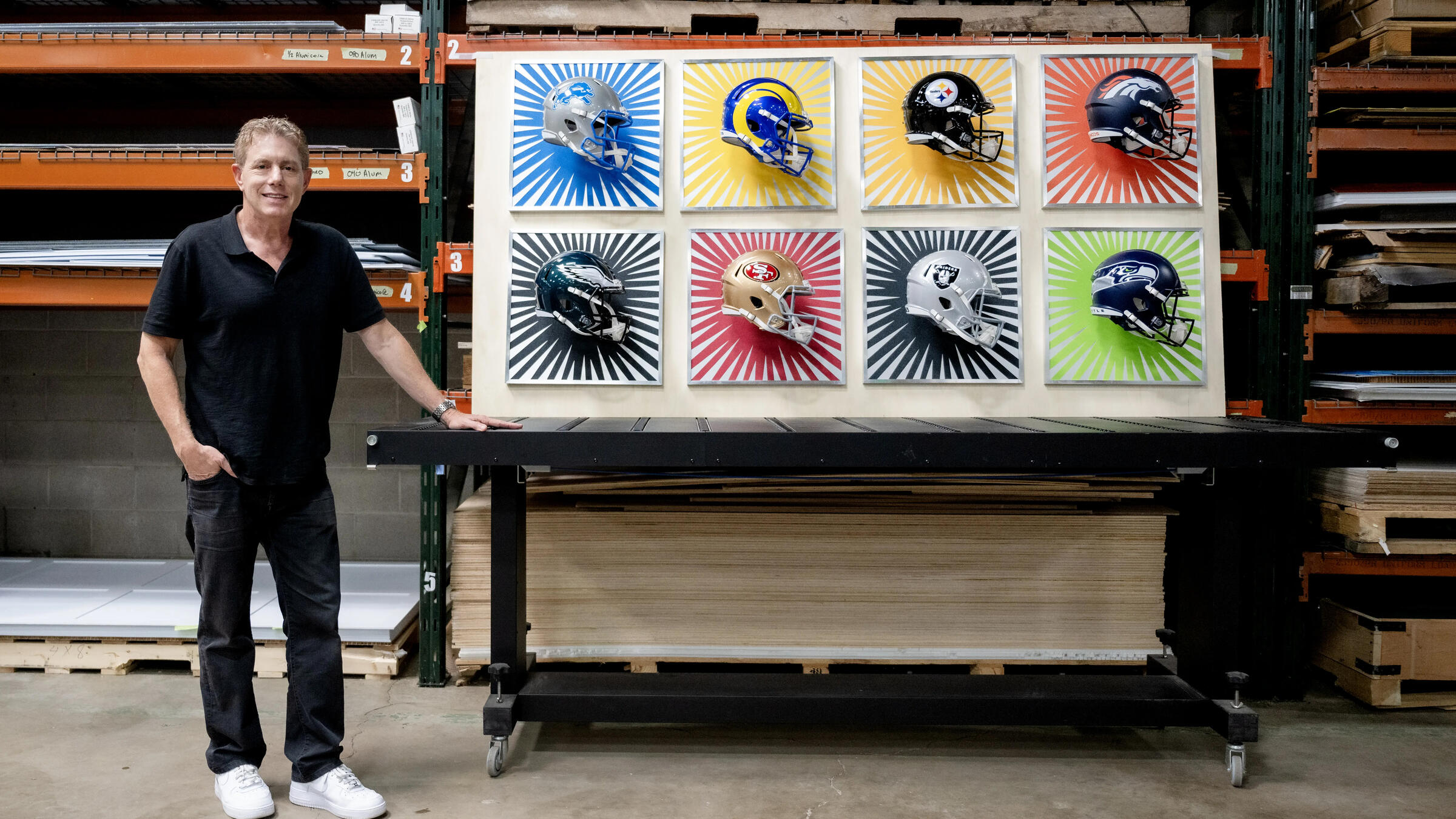 Burton Morris standing next to his NFL art