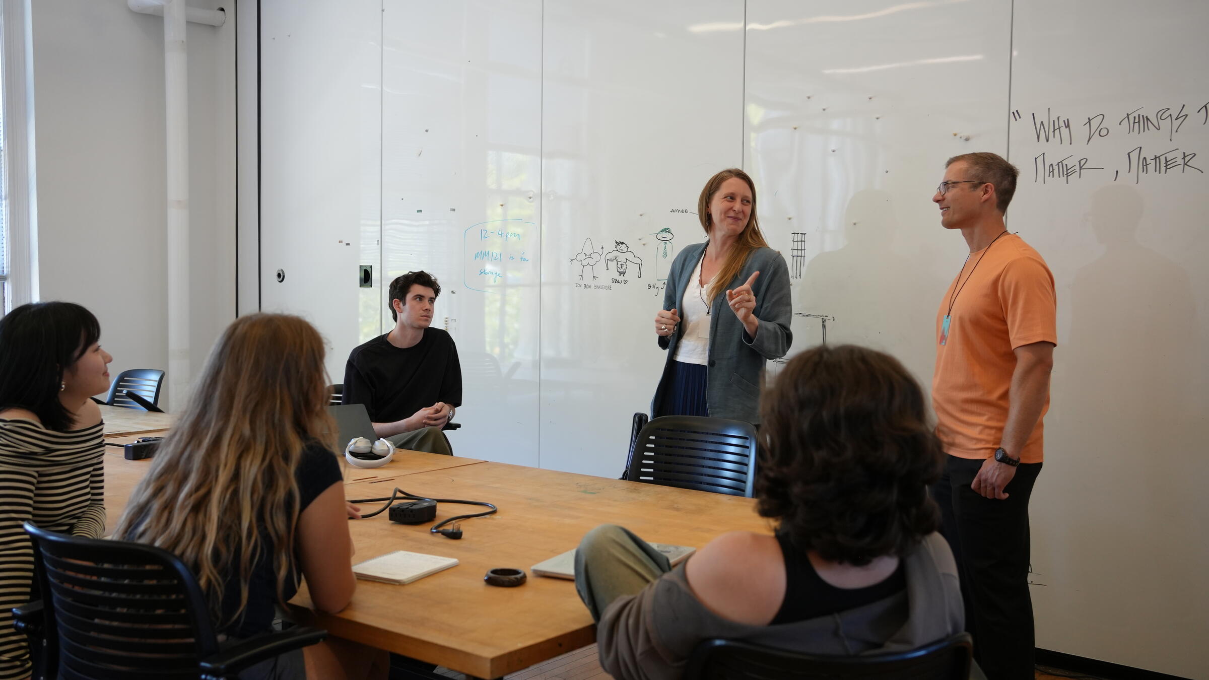 Design professionals speaking with students