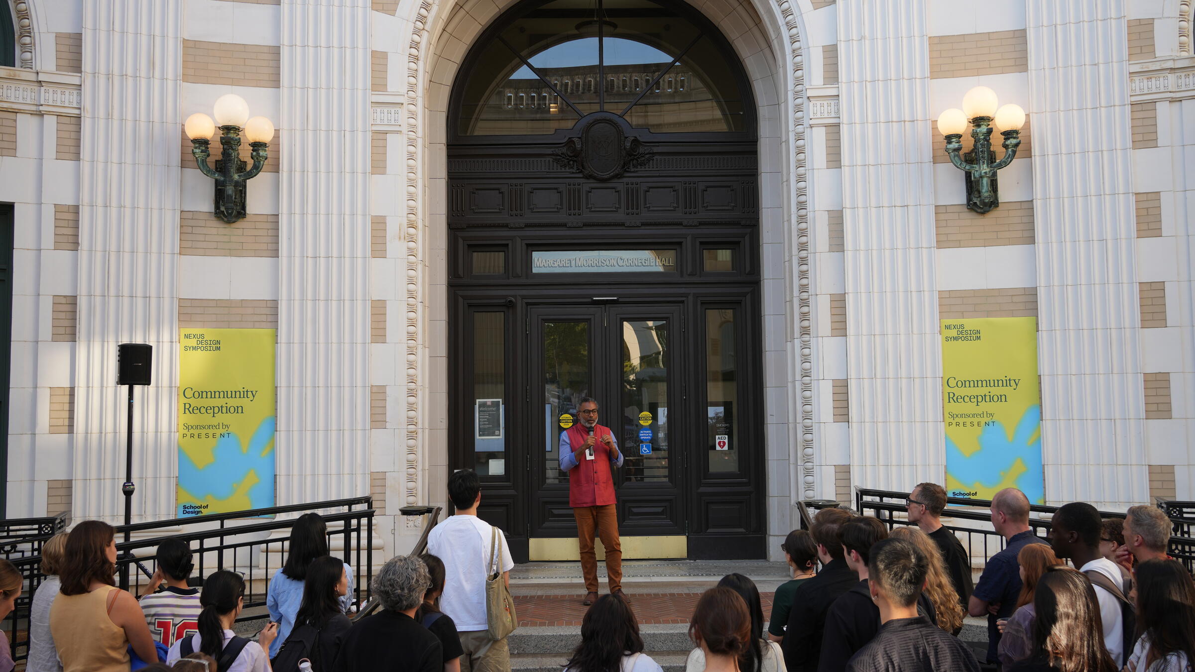 A man addressing a crowd in front of MMCH