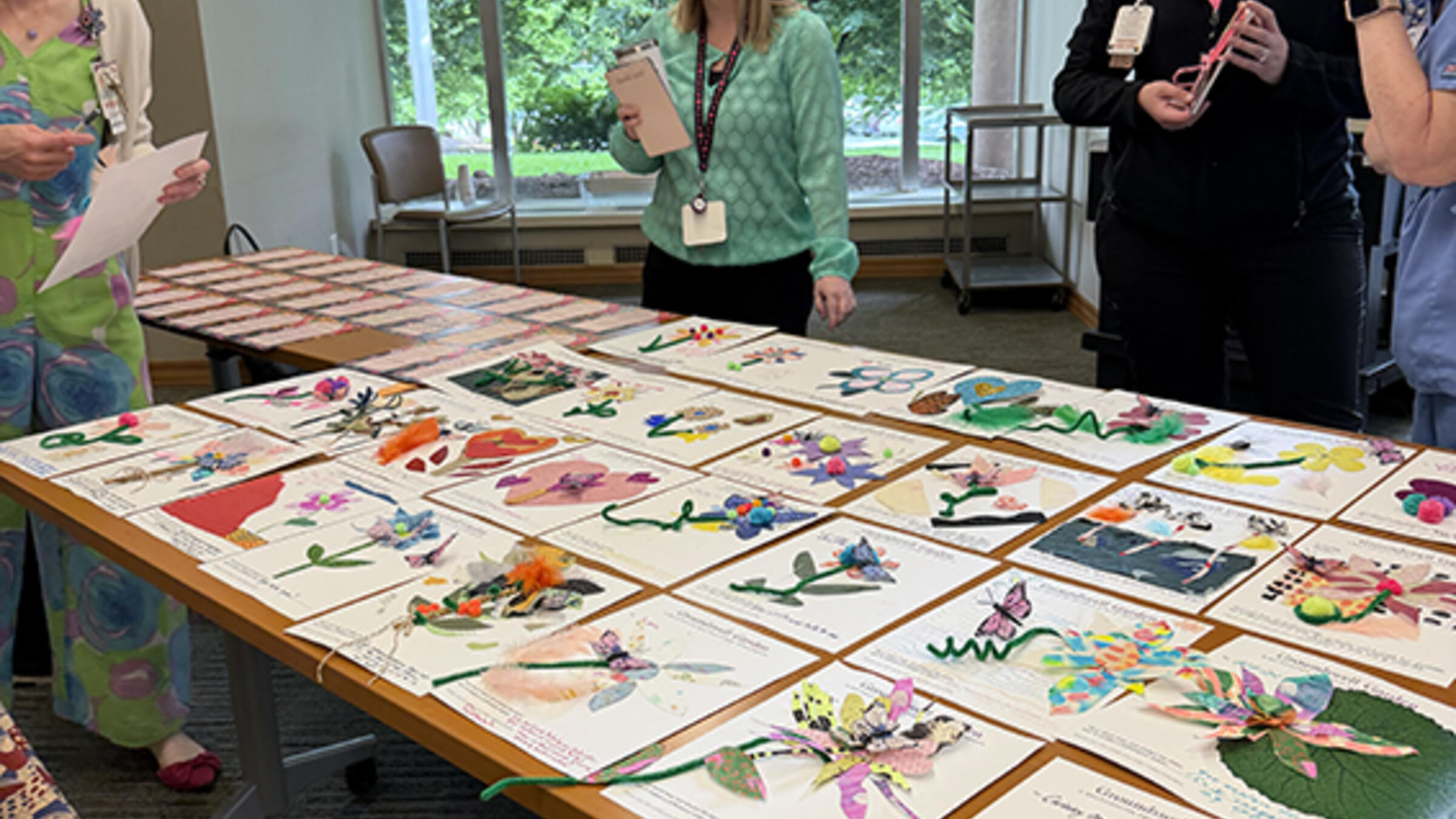 healthcare workers looking at their collages on a table