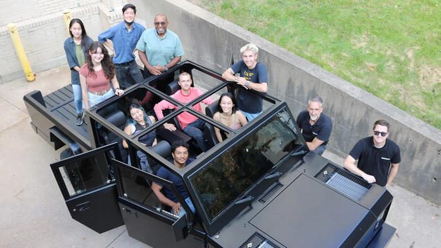 Design students posing with the Bollinger electric truck