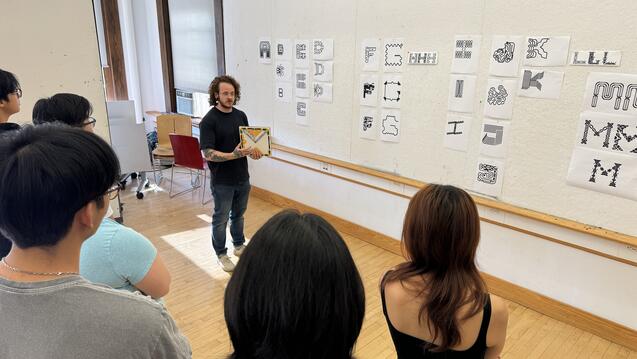 Kelsey Elder showing experimental typography to a class