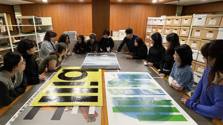 Communications students looking at work in the Hunt Library