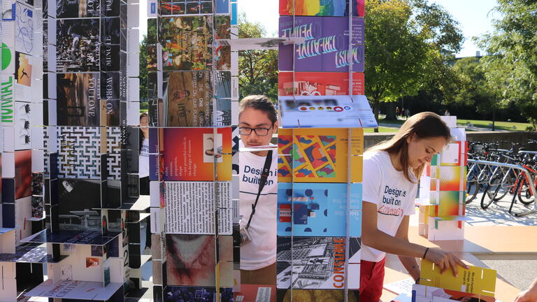 Students building a colorful tower of cards.