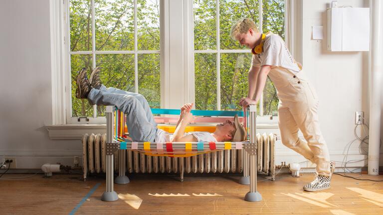 2 people sitting on a comfortable bench