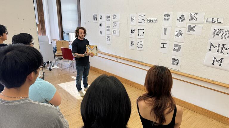 Kelsey Elder showing experimental typography to a class