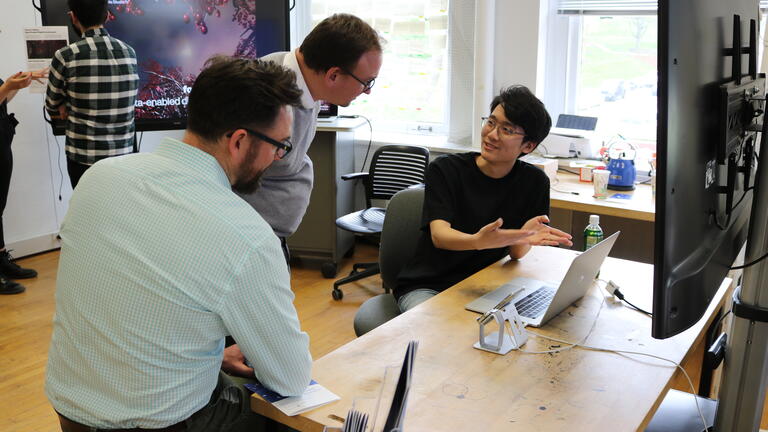 A student presenting to clients in a studio