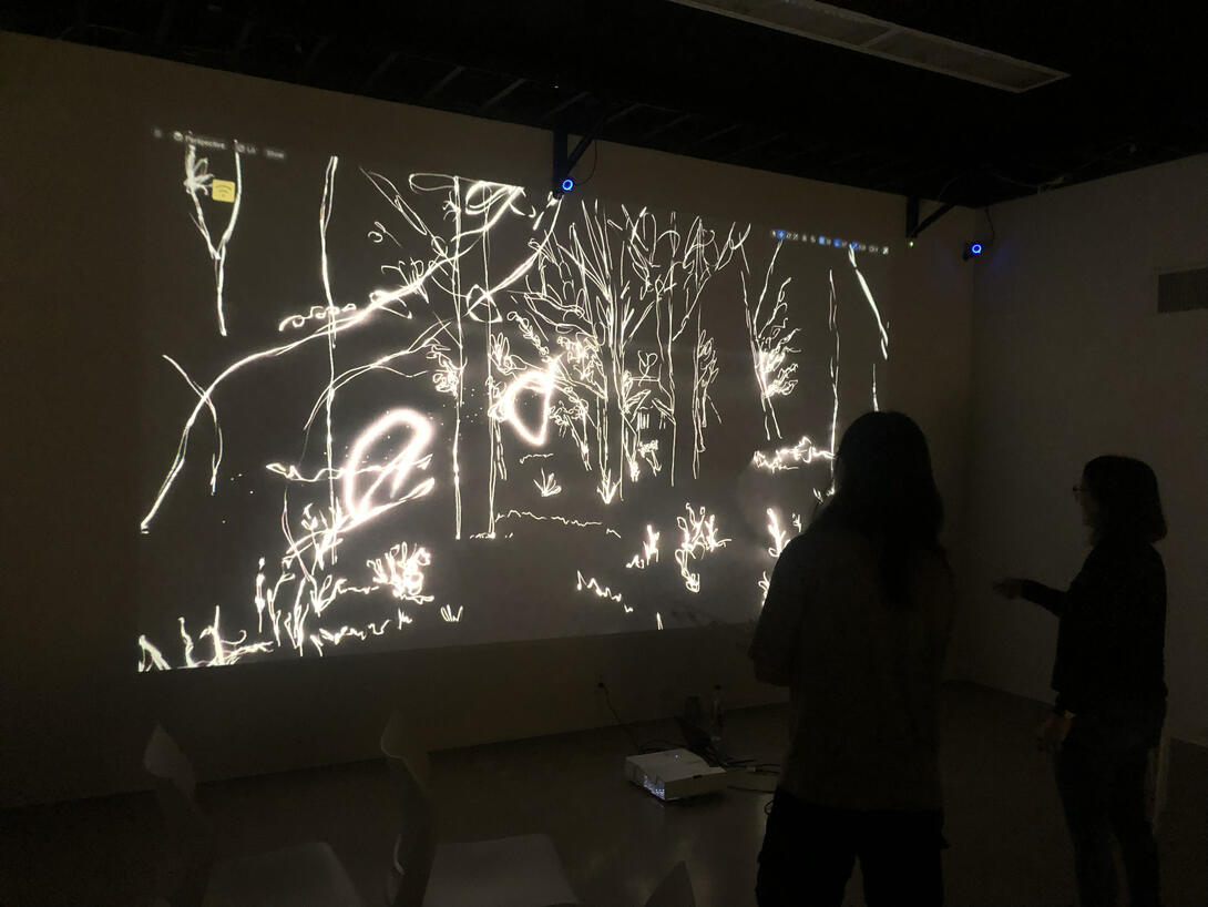 A person interacting with a screen in a dark room