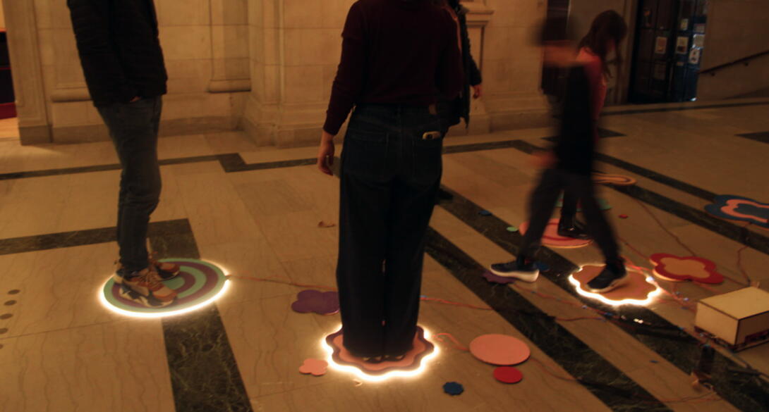 People standing on glowing pads