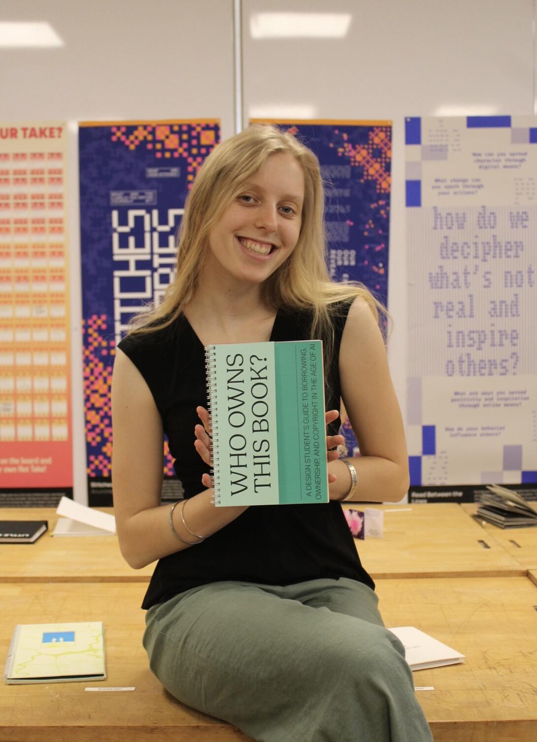 Michele Hratko posing with her book