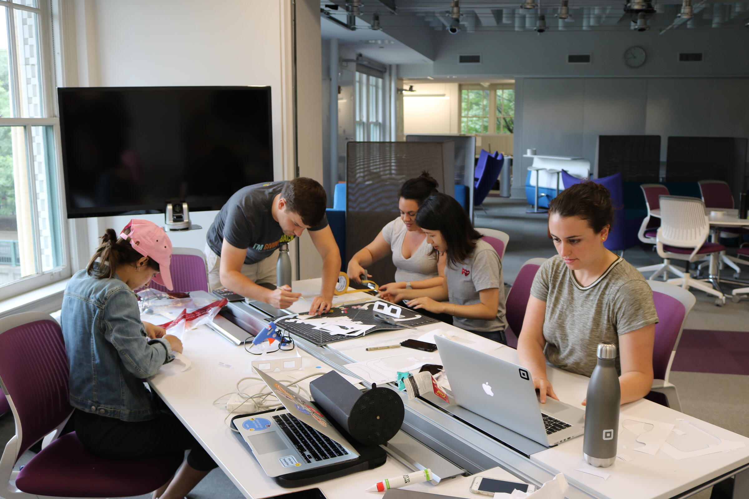 Master's Students working at a table in the grad studio.